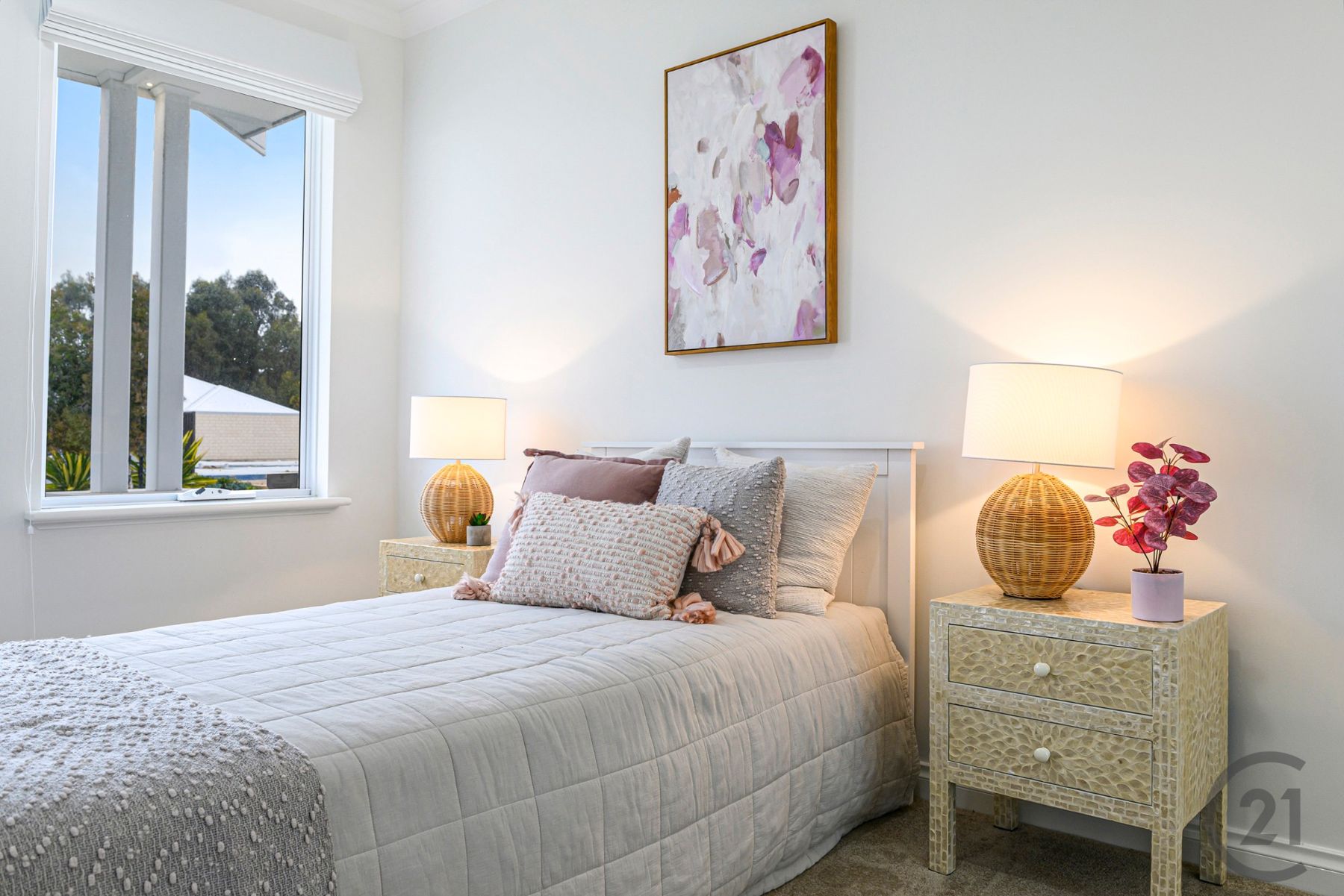 Bedroom with queen bed, rattan lamps and ceiling fan